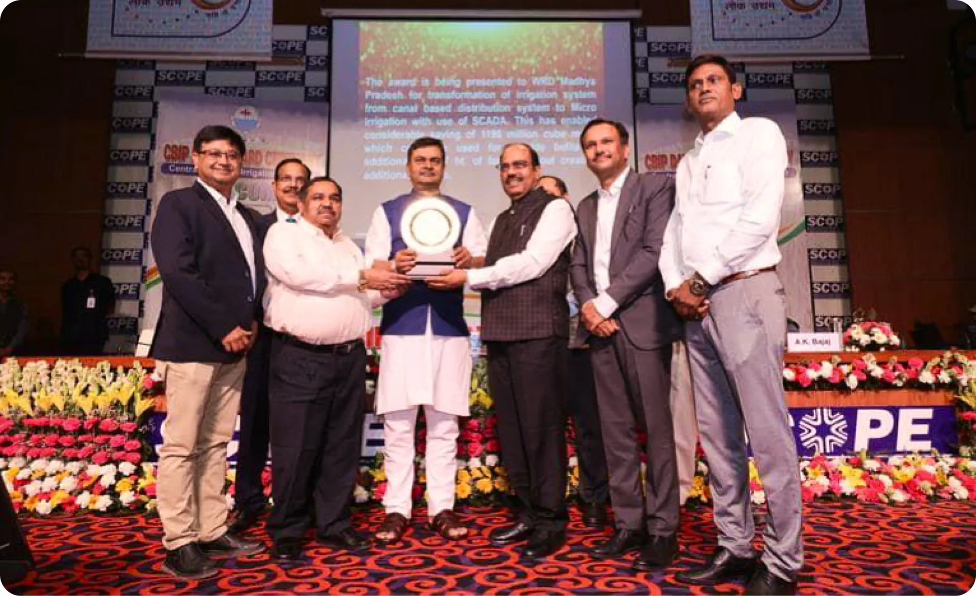 Madhya Pradesh Water Resources Department officials receiving the CBIP Award 2022 on stage at the SCOPE convention
