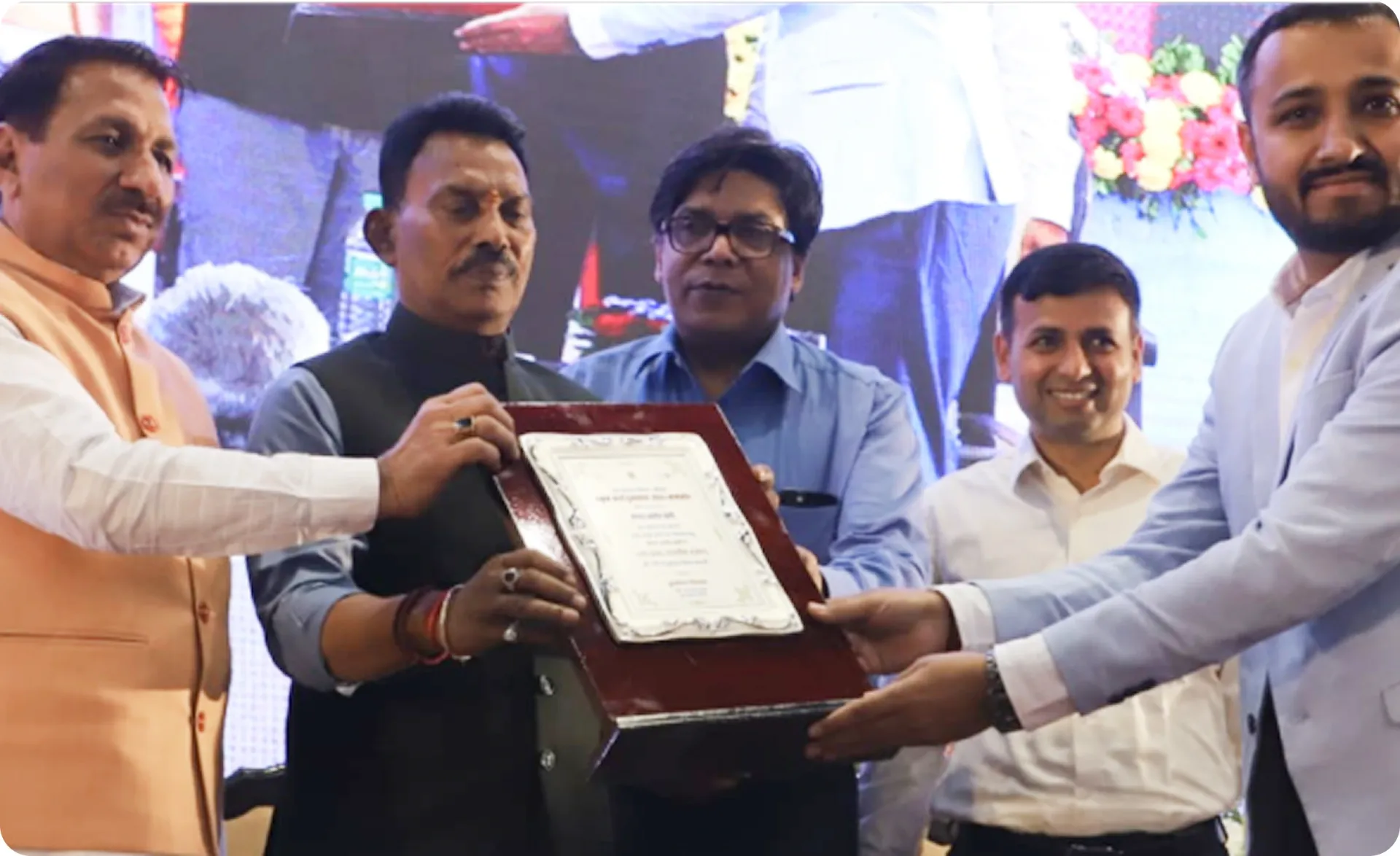 Mr. Vipin Tiwari receiving the basin-level excellence award plaque
