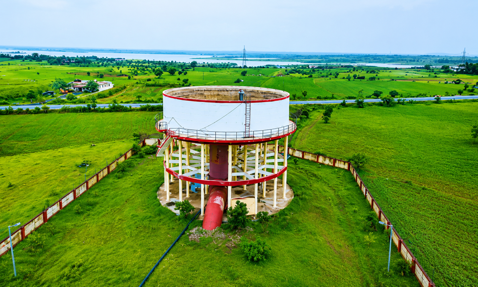 Elevated distribution chamber tank surrounded by green fields