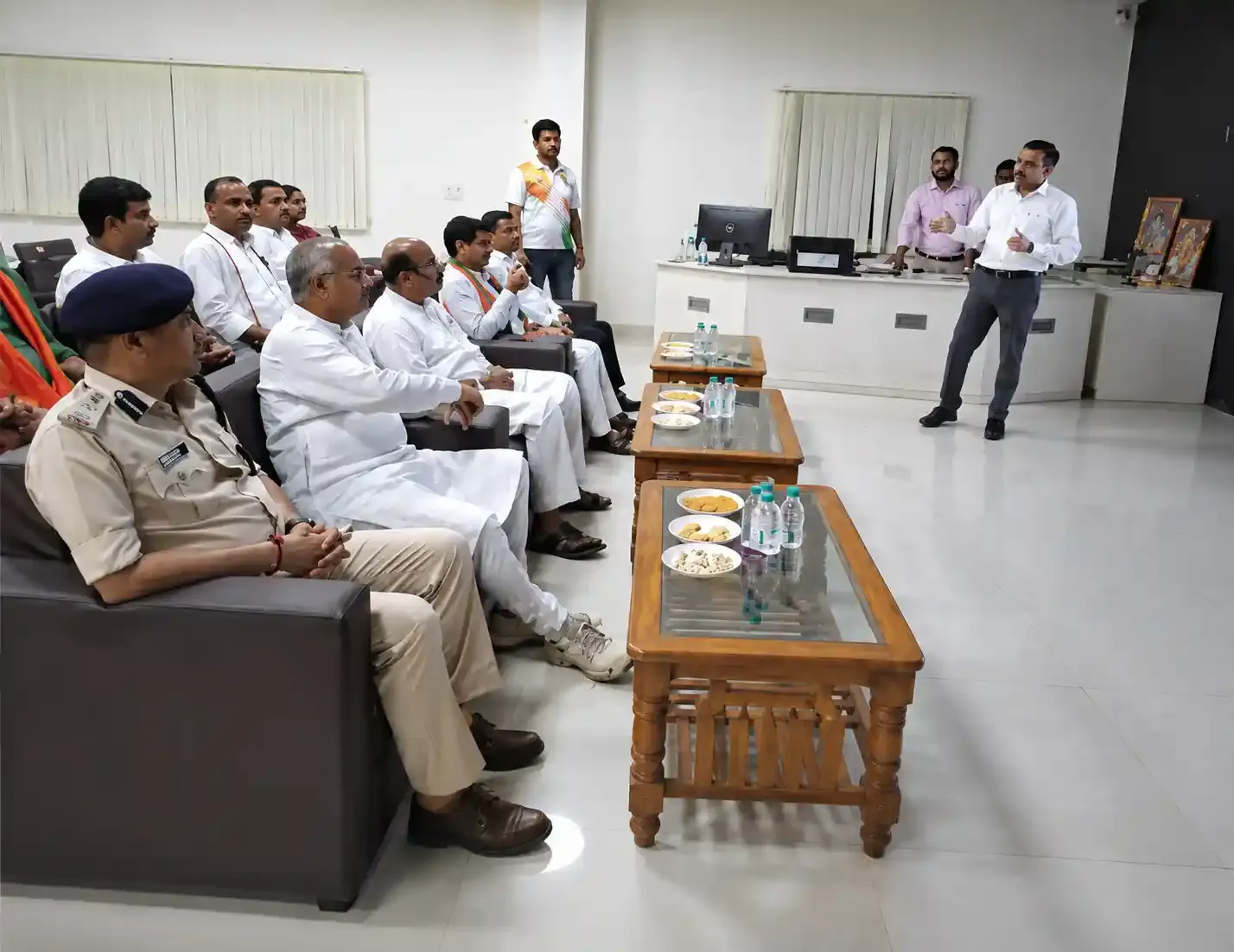 Delegation seated for a project briefing presentation in the control room